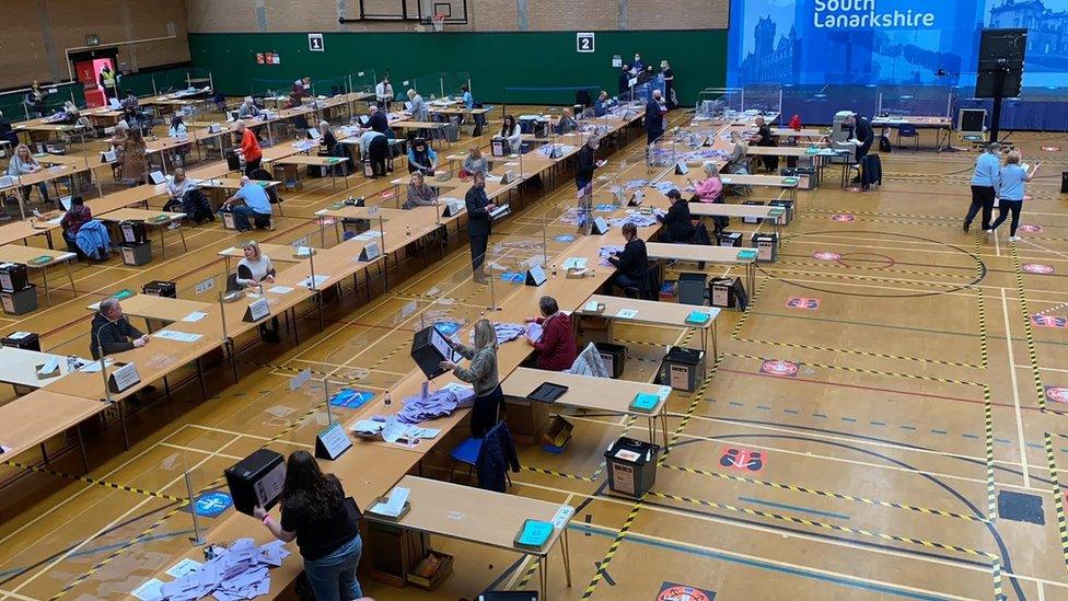 Counters sort through piles of lilac ballot papers to begin the count