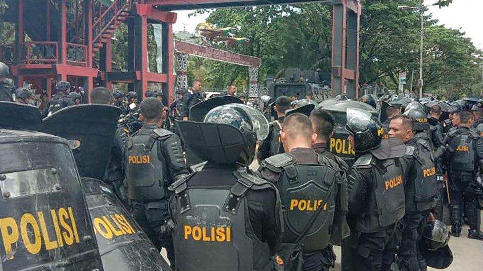 Indonesian riot police take positions at a university in provincial capital Jayapura on September 23, 2019