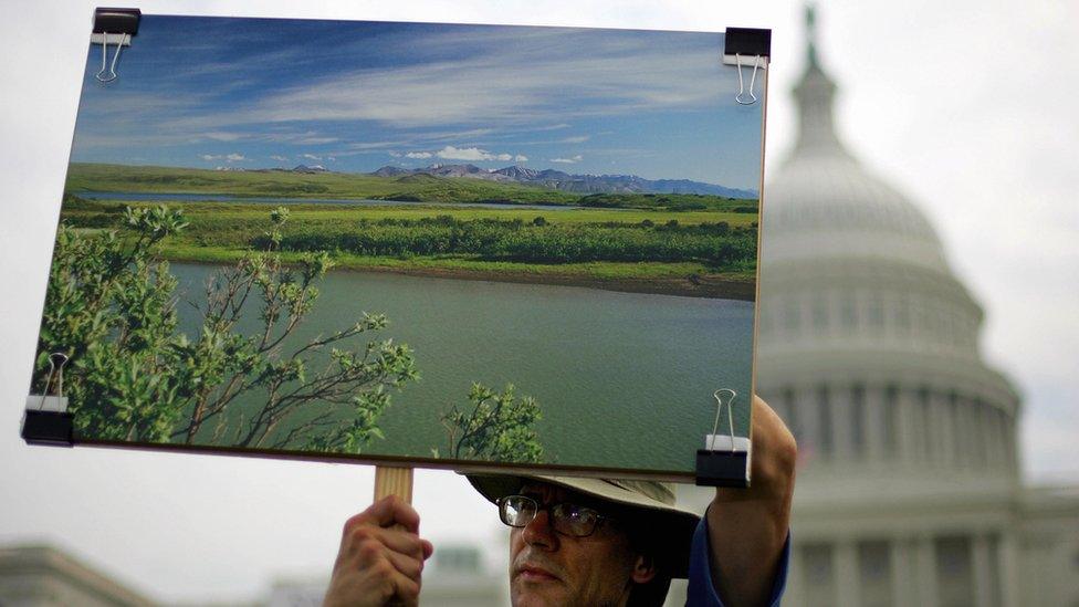 Thomas Joswiak, of Grand Rapids Michigan holds a photograph of the Arctic National Wildlife Refuge (ANWAR) at a large rally on the West Lawn of the US Capitol 20 September, 2005 in Washington, DC.