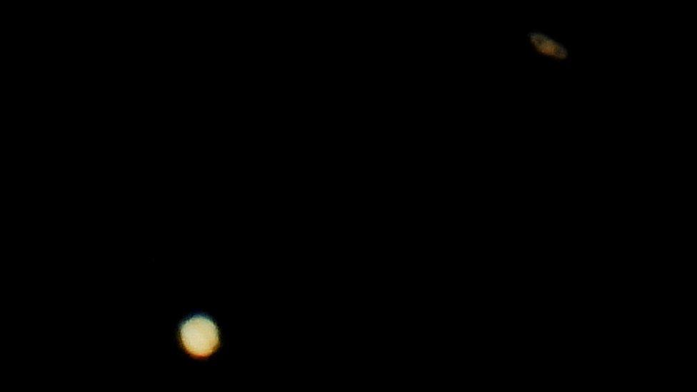 Jupiter (below) and Saturn (above) are pictured on the sky during the closest visible conjunction of them in 400 years, in La Linea de la Concepcion, southern Spain