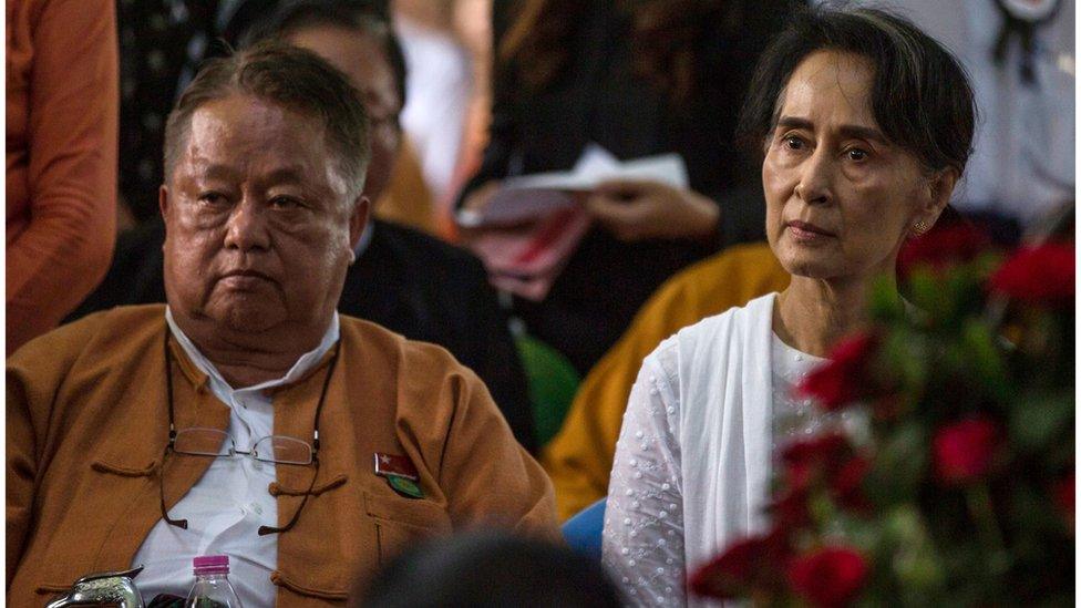 Myanmar's State Counselor Aung San Suu Kyi (R) and Win Htein, chief executive committee members of the National League for Democracy (NLD), attend the funeral service for the party's former chairman Aung Shwe in Yangon on August 17, 2017.