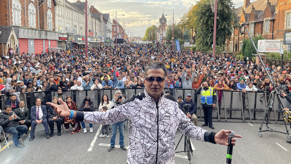 Musician standing in front of crowds