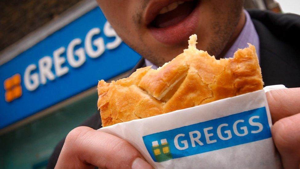 Man eating Greggs pasty