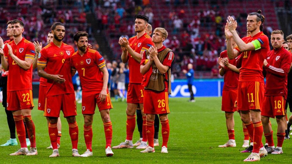 Wales players applaud their fans after being defeated by Denmark in Amsterdam