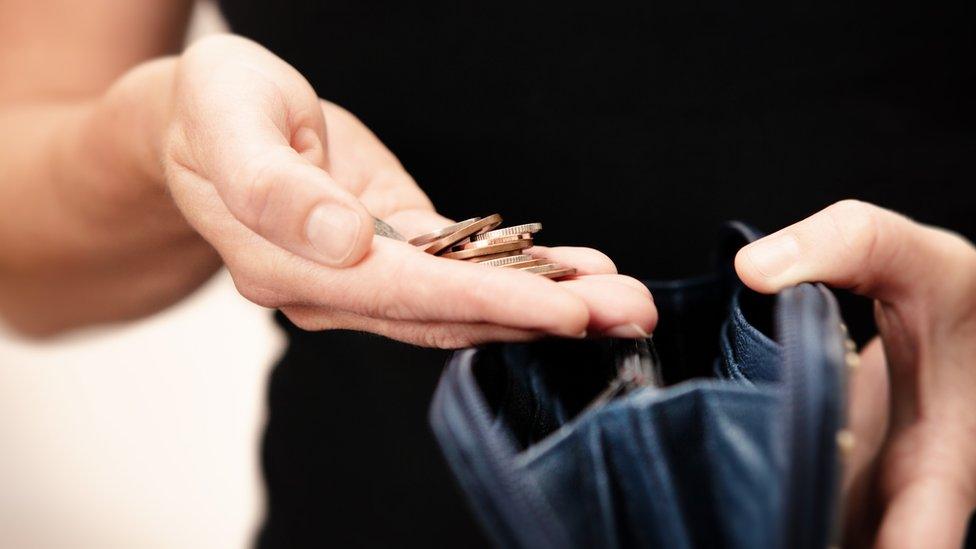 Hand holding coins