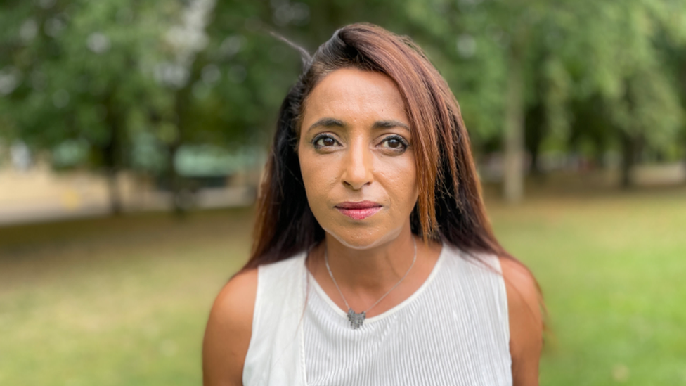 A woman wearing a white top