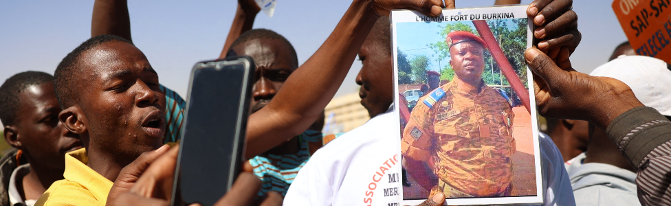 Demonstrators gathering in Ouagadougou to show support to the military hold a picture of Paul-Henry Sandaogo Damiba the leader of Burkina Faso's coup - 25 January 2022