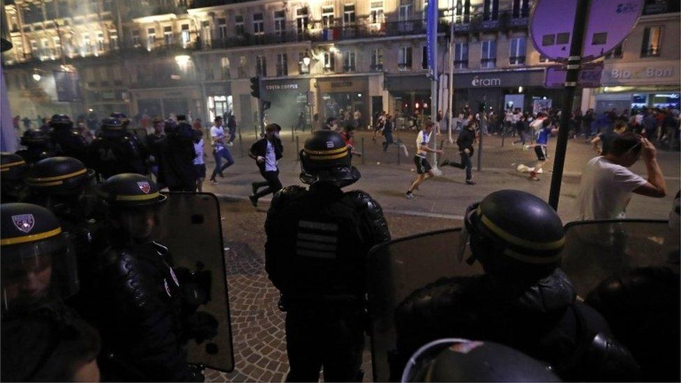 Football fans running after police fired tear gas