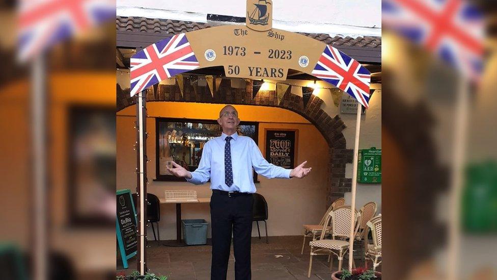 Vic Long stood under a banner marking 50 years of The Ship