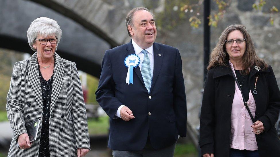 Alba party leader Alex Salmond in Ellon walking with two women