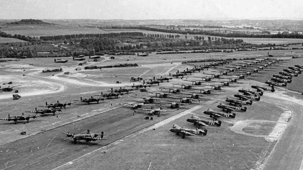 Black and white photo looking down on lines Halifax bombers and gliders on Tarrant Rushton airfield on 6 June 1944