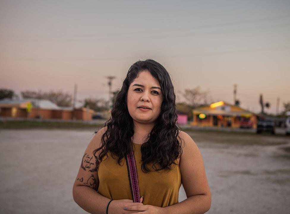 Maria Castro outdoors with buildings in the distance