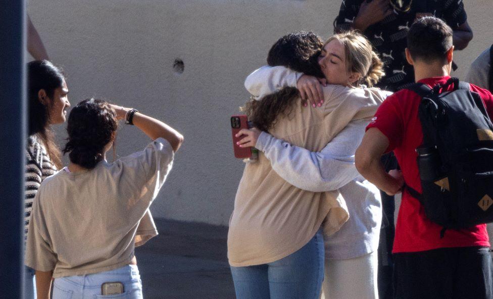 Pepperdine University students embrace at vigil