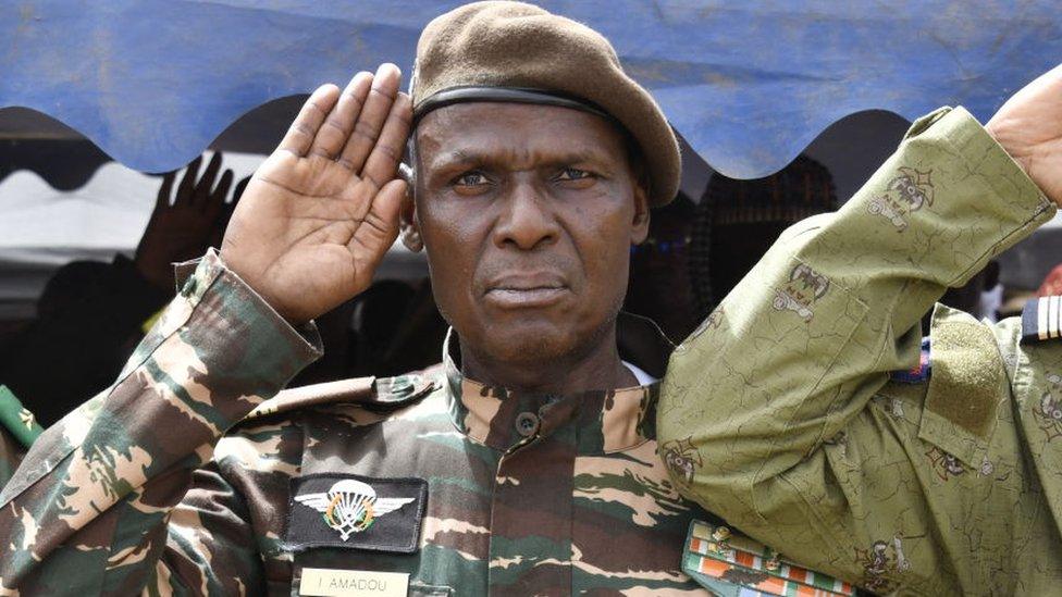 Colonel Ibro Amadou, an influential member of the military regime in power in Niger, gives a military salute while attending a demonstration for the immediate departure of United States army soldiers deployed in northern Niger in Niamey, on 13 April.