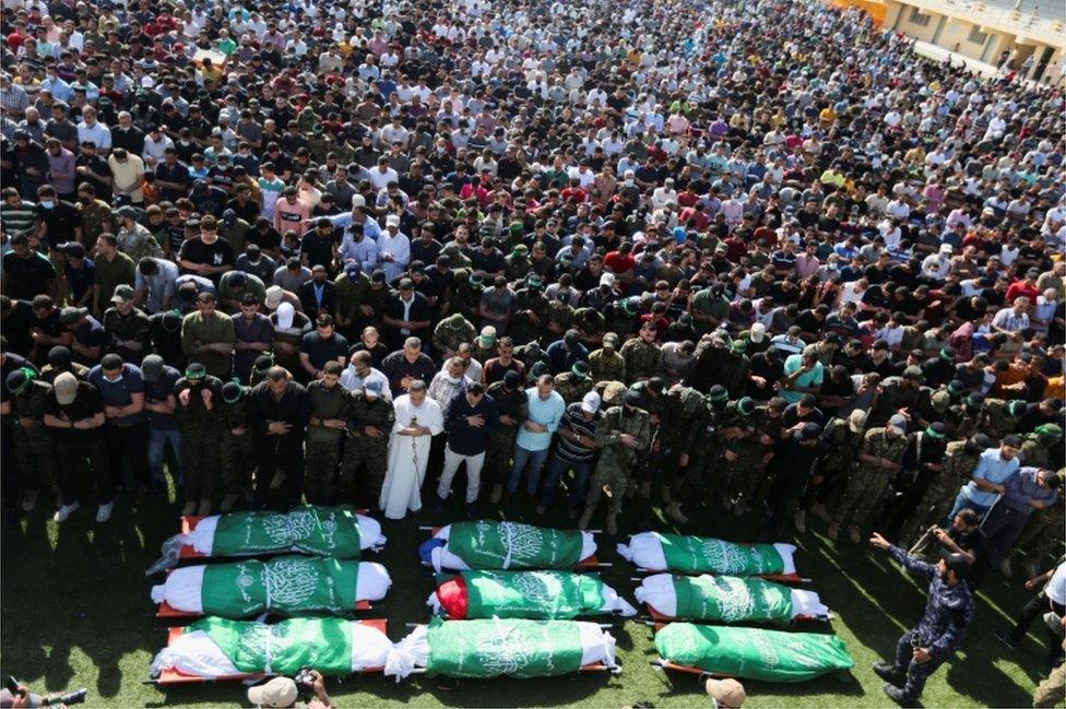 Thousands of people in Khan Younis attend a funeral for Palestinians killed during Israeli-Palestinian fighting, held on 21 May