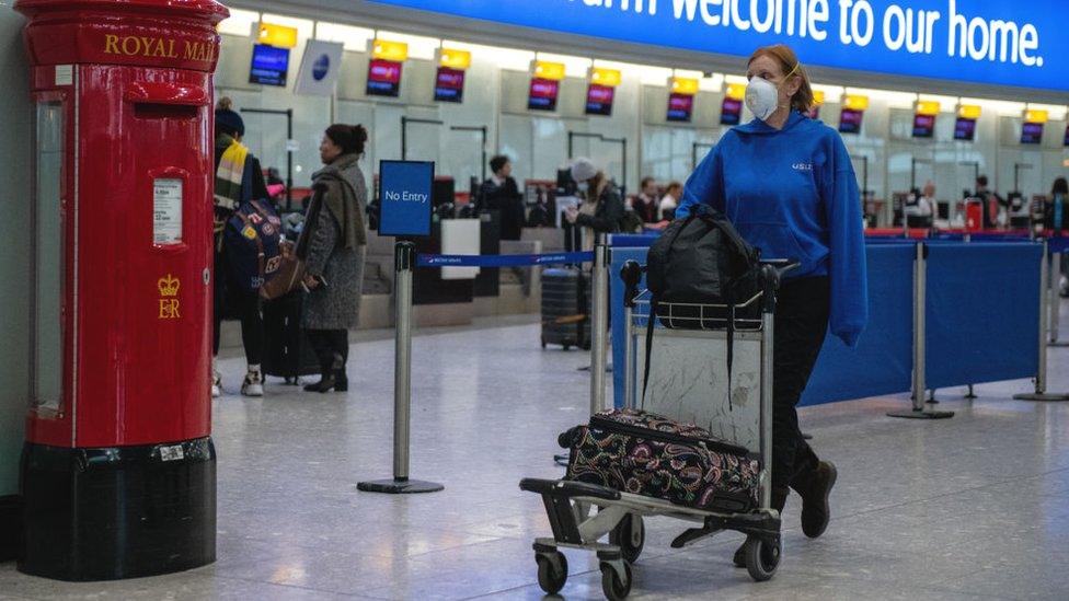 Passenger with mask at Heathrow Airport