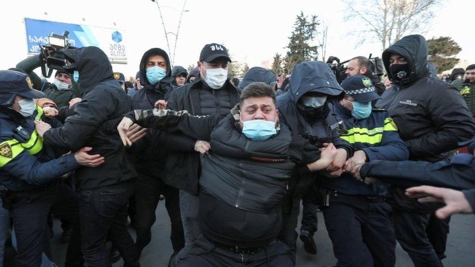 Georgian law enforcement officers detain an opposition supporter after storming the United National Movement (UNM) opposition party office in Tbilisi, Georgia on 23 February 2021