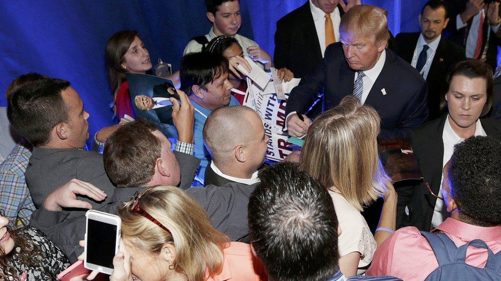 Trump signs autographs