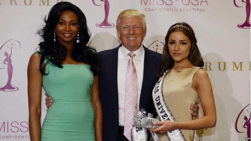 Donald Trump poses with new Miss USA Nana Meriwether (c) after she is crowed by newly appointed Miss Universe Olivia Culpo (L) at the Trump Tower January 9, 2013. Nana Meriwether, first runner up in the Miss USA 2012 Pageant will be taking over Miss USA"s reign after Olivia Culpo won the Miss Universe 2012 title, the last time this happened was 1997. AFP PHOTO /