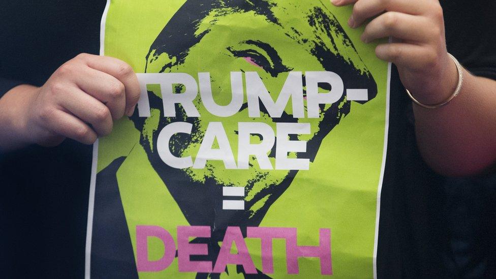 A protester holds a sign the Republican-crafted healthcare bill that would replace the Affordable Care Act,