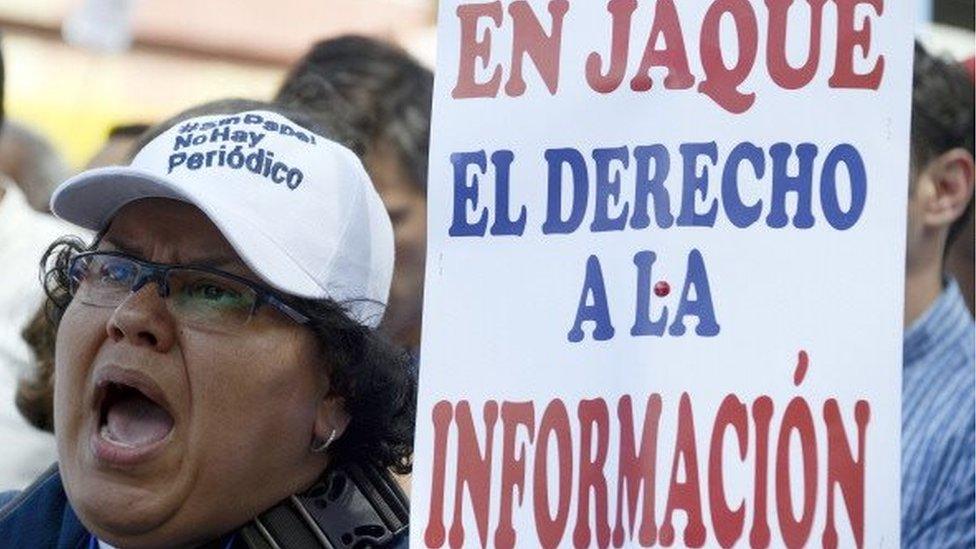 Journalists take part in a protest outside the CADIVI headquarters in Caracas on February , 2013