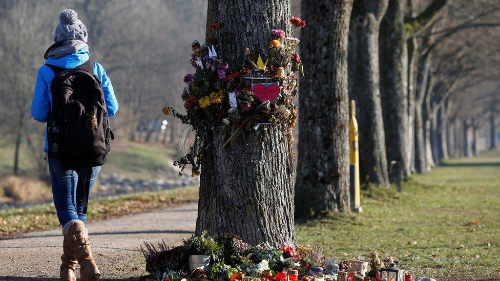 A woman walks past the spot where Maria L died