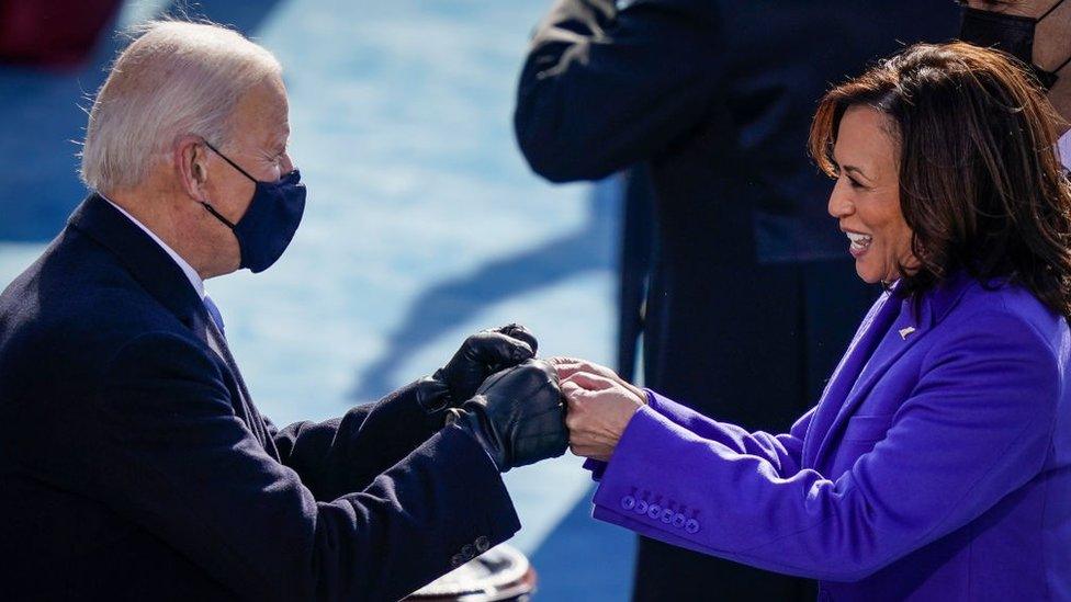 Joe Biden and his Vice-President Kamala Harris fist bump after they are sworn in