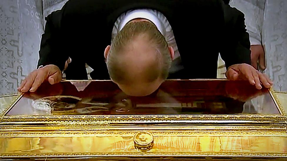 Putin kissing the box holding the rib of St Nicholas