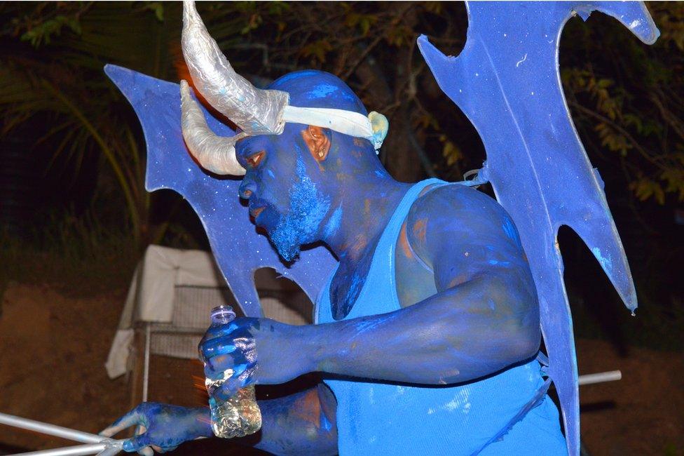 Samuel Thomas performs as a blue devil