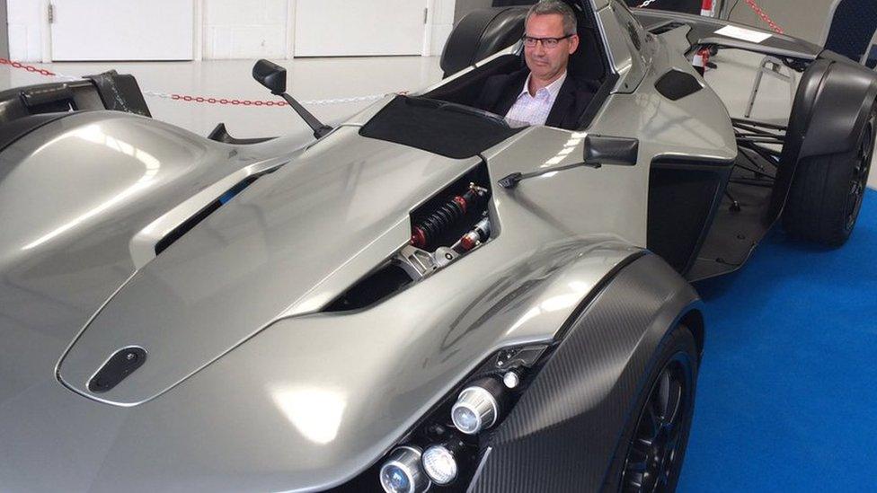 James Baker, commercial director of the National Graphene Institute, sits in the world's first car with graphene in its bodywork