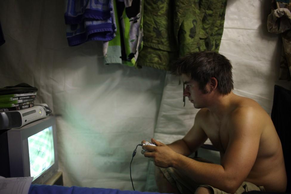 Member of the armed forces playing games while on tour in Kandahar in 2008