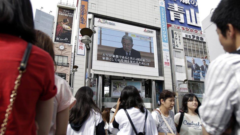 Pedestrians watch a large screen broadcasting Japanese Emperor Akihito"s video message on his thoughts, in Tokyo, Japan, 08 August 2016.