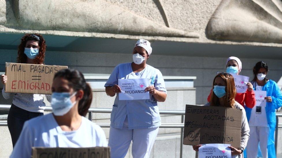 Nurses hold placards during a protest demanding better working conditions outside La Paz hospital amid the outbreak of the coronavirus disease