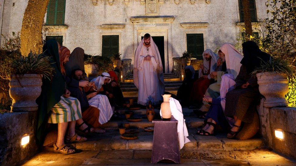 Actors perform the Last Supper scene during the interactive street theatre Passion play 'Il-Mixja' (The Way), one of a series of Holy Week activities in the run-up to Easter, in the gardens of Verdala Palace outside Rabat, Malta