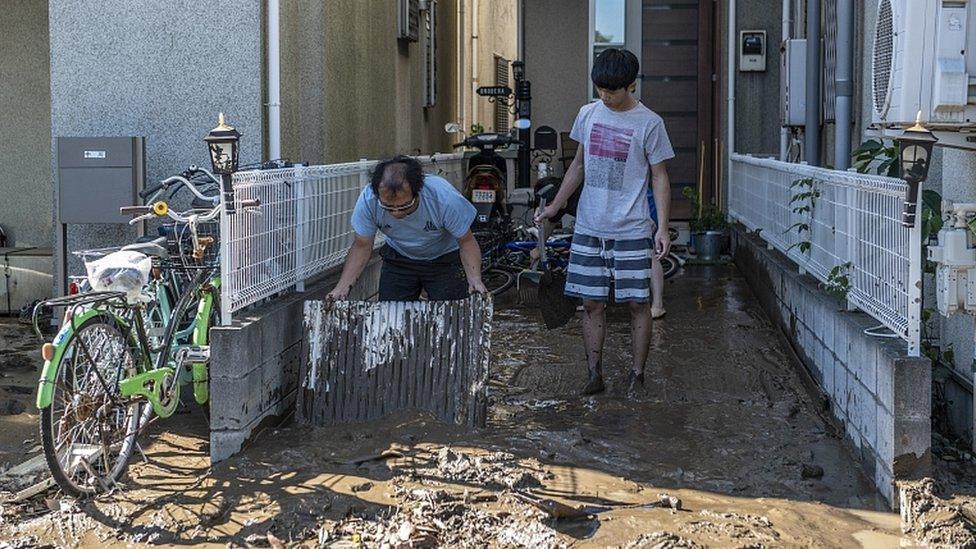 People clear mud from their homes after being flooded during Typhoon Hagibis, on October 13, 2019 in Kawasaki, Japan