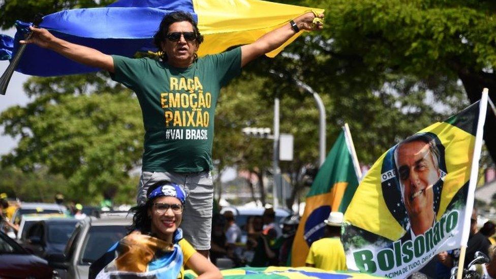 Supporters of Brazils far-right presidential candidate Jair Bolsonaro take part in a campaign rally in Brasilia, on October 6, 2018.