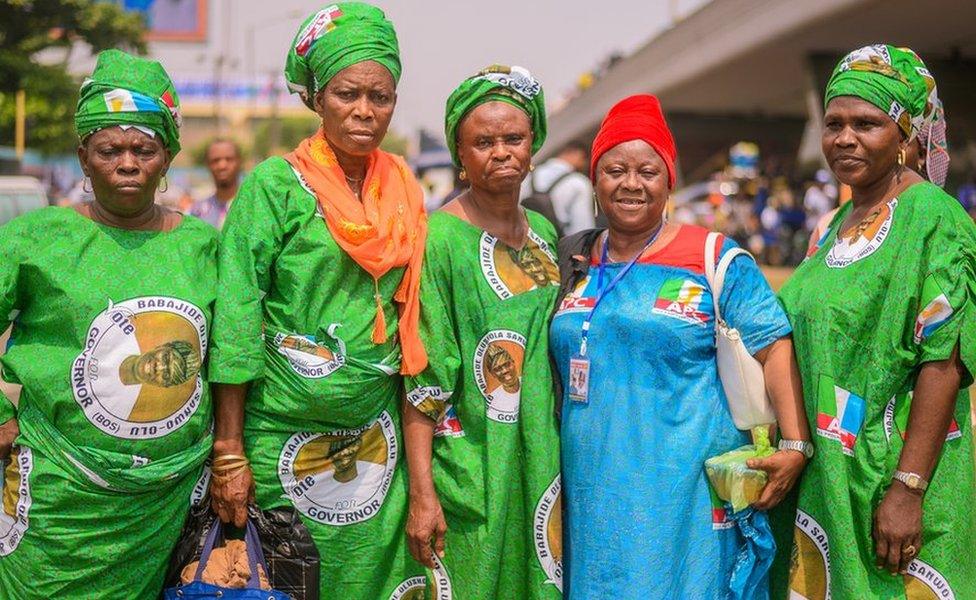 Group of women wearing green and blue attire