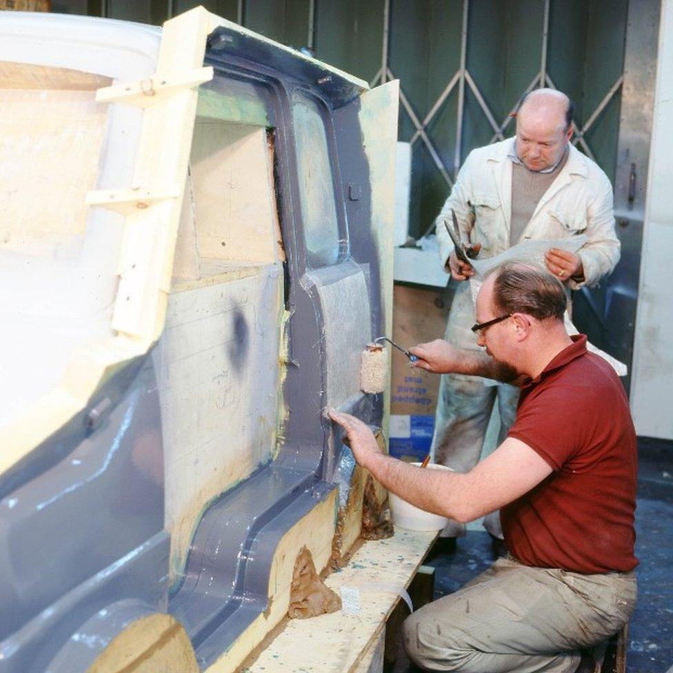 Workers making the Comuta