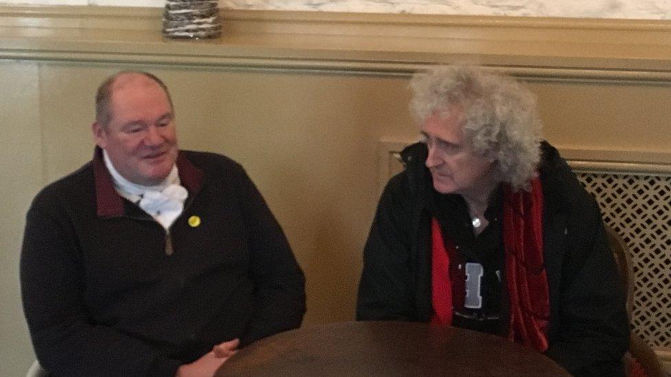 Byron John chatting with Brian May