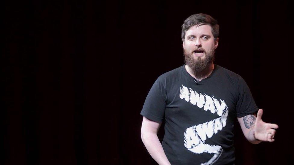 Johnny Chiodini addresses the audience at a mental health TED Talk.