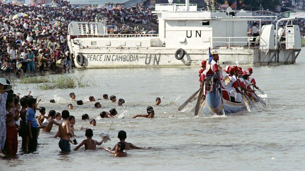 A UN warship watches over the water festival, on November 8, 1992, in Phnom Penh