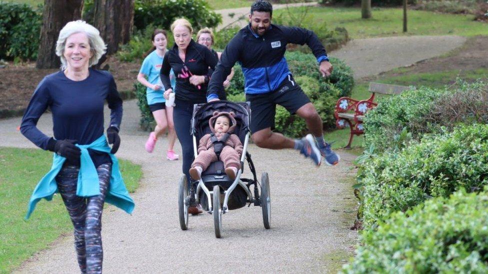 Emon Choudhury running with his one-year-old daughter Lilly