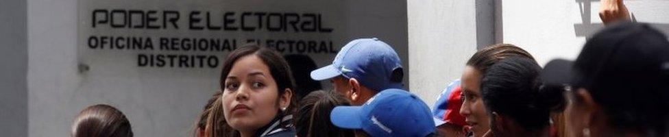 People gather outside a validation centre during Venezuela's CNE second phase of verifying signatures for a recall referendum against President Maduro, in Caracas, Venezuela, June 24, 2016.