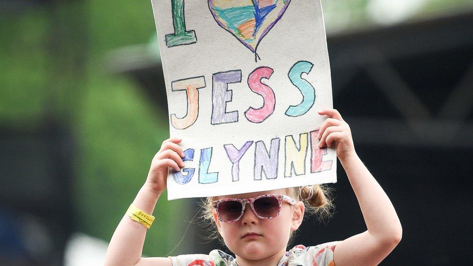 A girl holds a banner in the crowds during the first day of BBC Music's Biggest Weekend at Singleton Park, Swansea