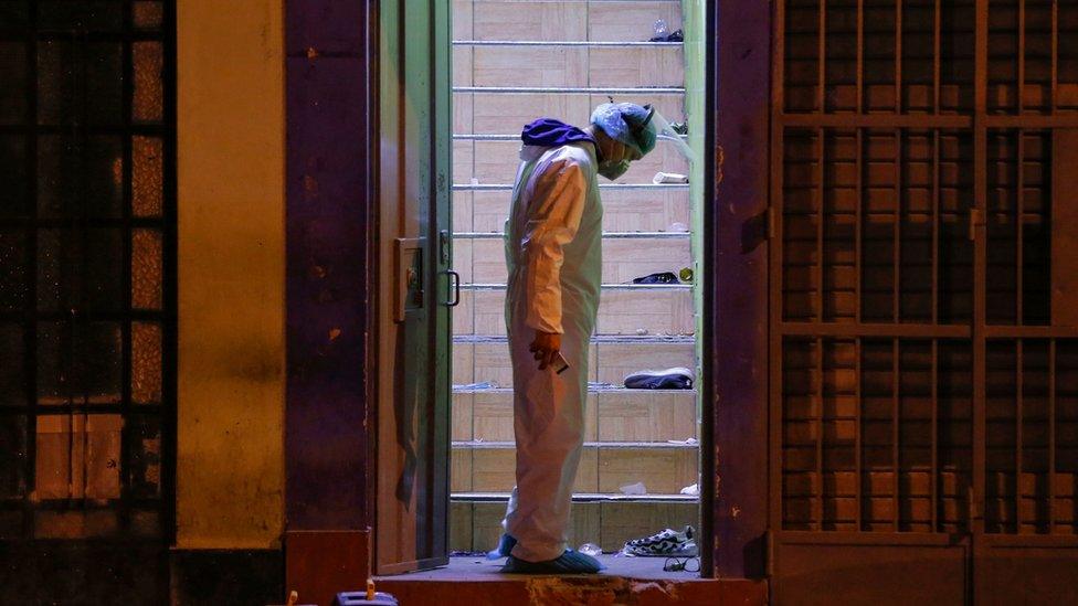 Police investigator stands on the site where 13 people were killed in a crush at a nightclub doorway on 22 August 2020