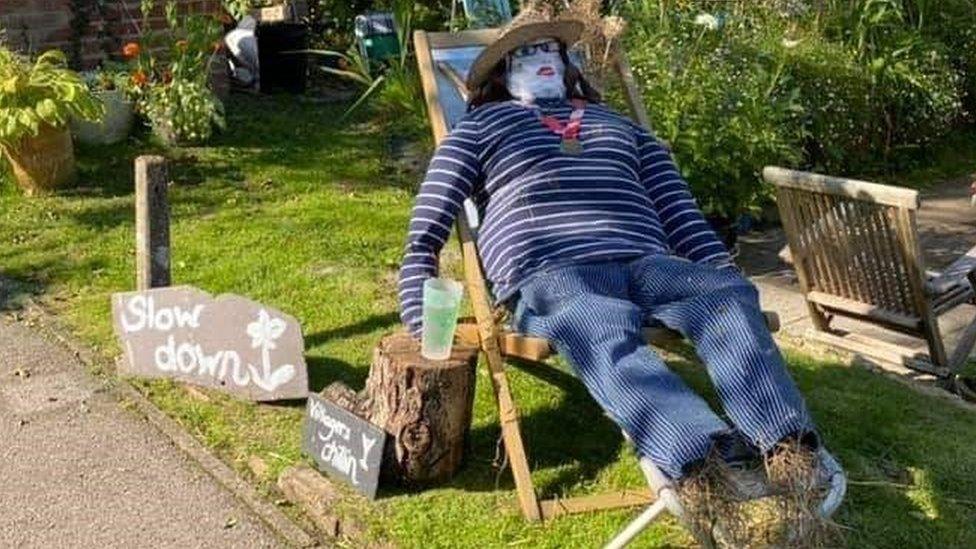 Scarecrow sitting in a deckchair