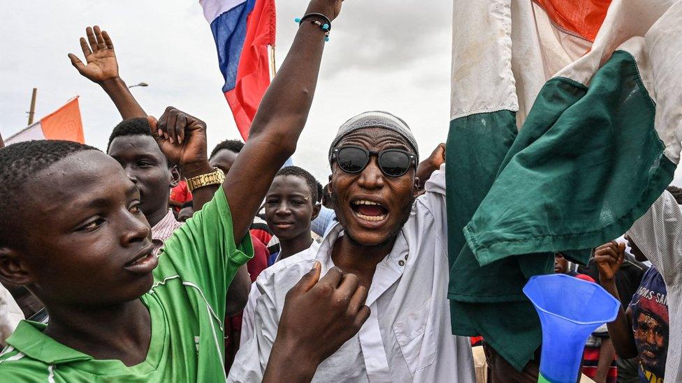 Protesters outside French military base.