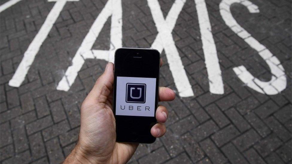 A smart phone showing the Uber app logo