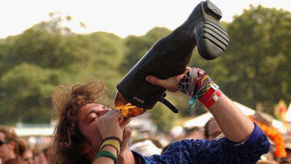 A man drinking from a welly