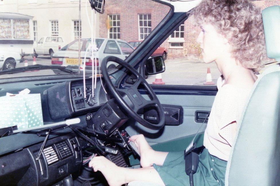 A woman driving using her feet